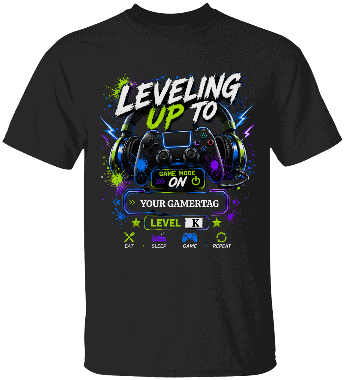 A black short-sleeve t-shirt with a colorful video game graphic on the front. The graphic features a video game controller, headphones, neon paint splatters in green, blue, and purple, and stylized text reading 'LEVELING UP TO' along with game-themed icons.